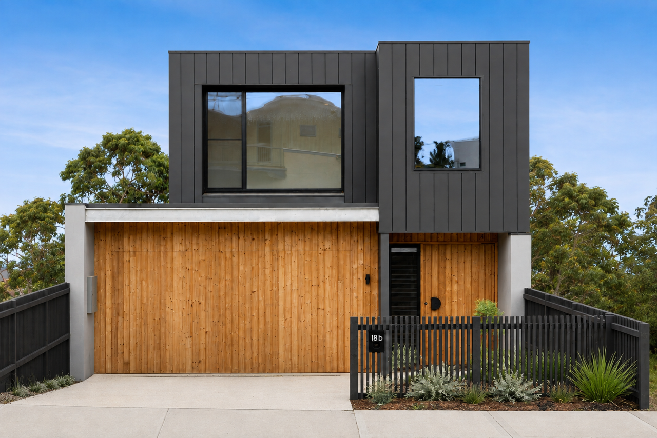 Halibut Avenue exterior with dark metal cladding and a warm timber entry