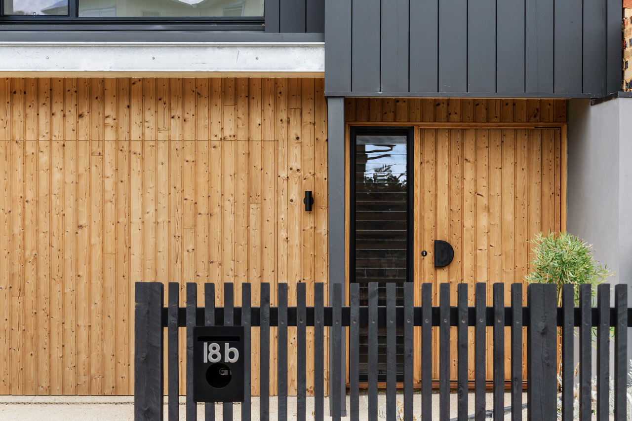 Halibut Avenue entry and garage framed by dark metal cladding