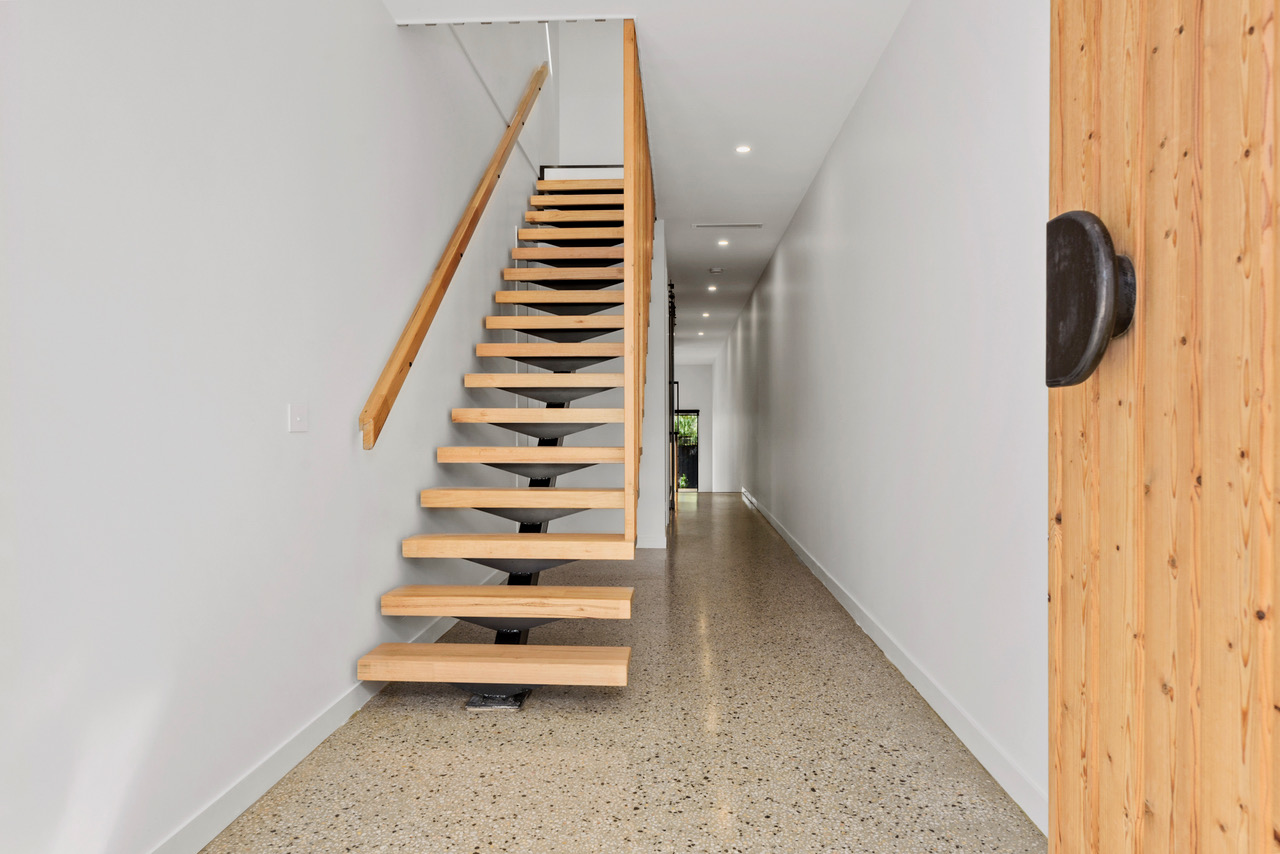 Halibut Avenue entry staircase with timber treads and a curved wall