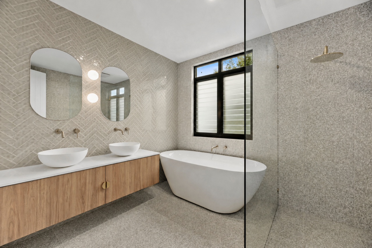Halibut Avenue bathroom with a freestanding bath and dark floor tiles