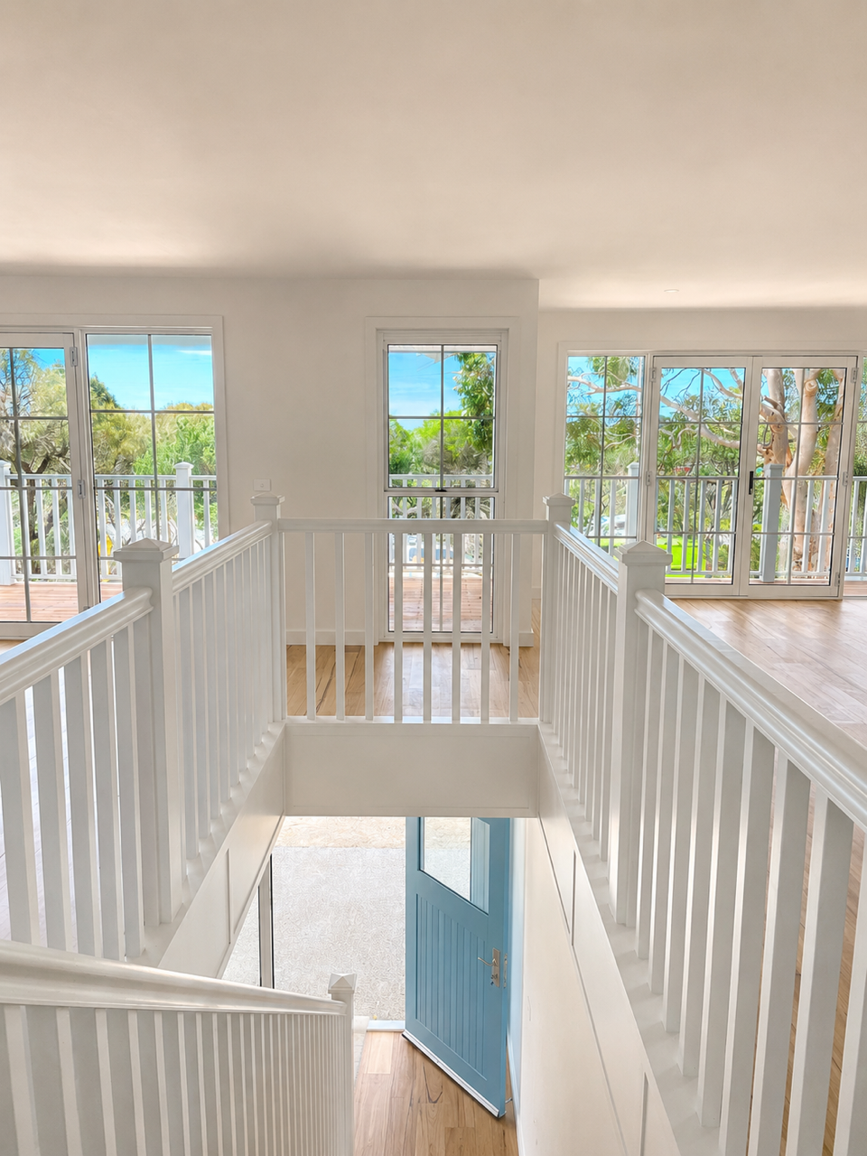 Shell Road timber staircase beside a stone feature wall