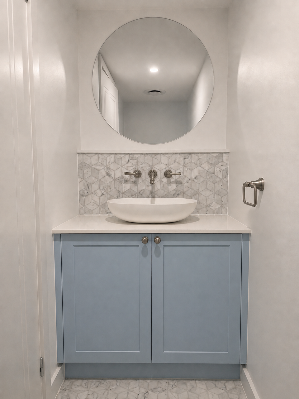 Shell Road powder room with stone detailing and a round mirror