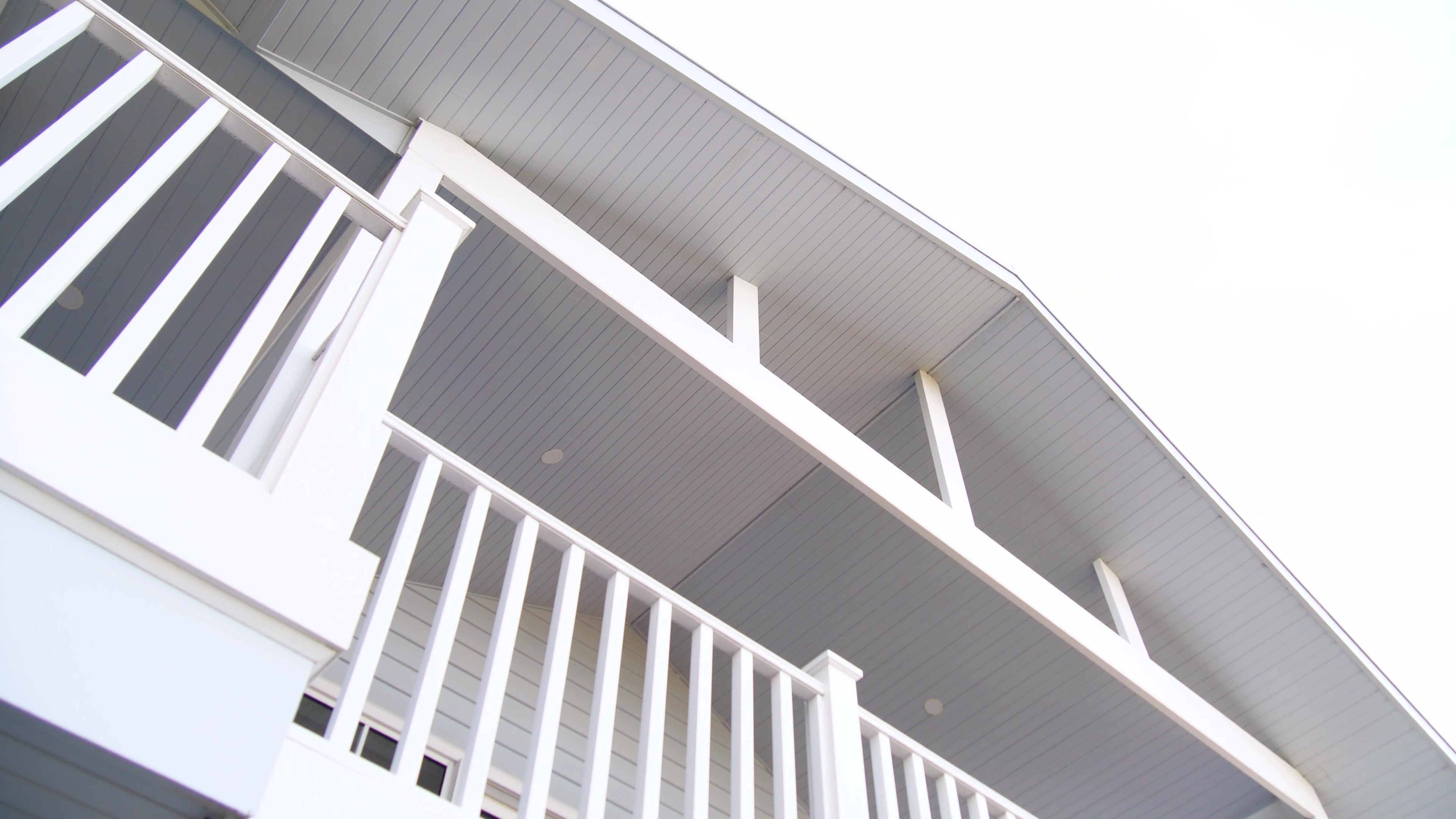 Shell Road exterior with white balcony railings and grey weatherboard cladding