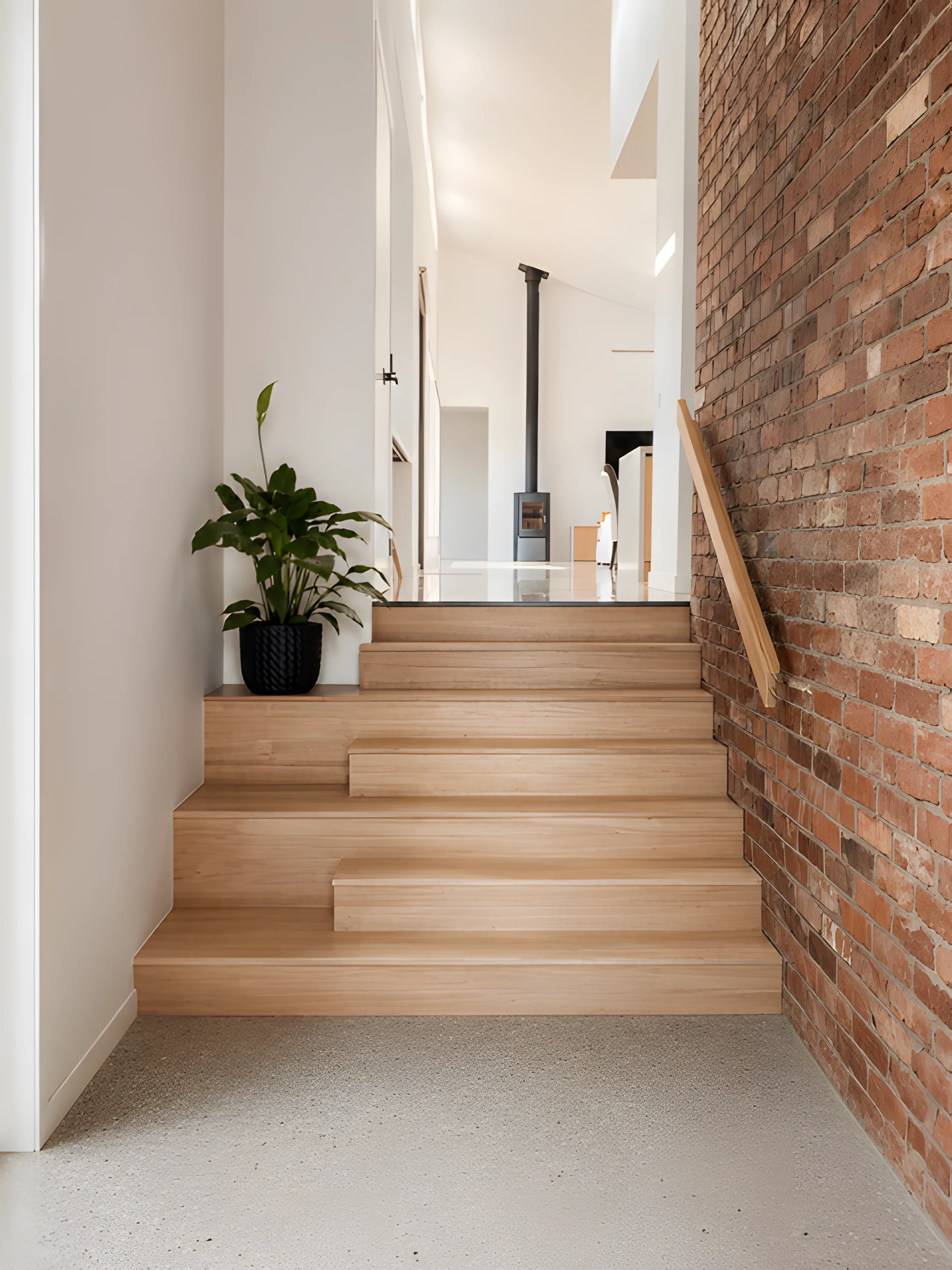 Conran Drive timber staircase beside a tactile brick wall