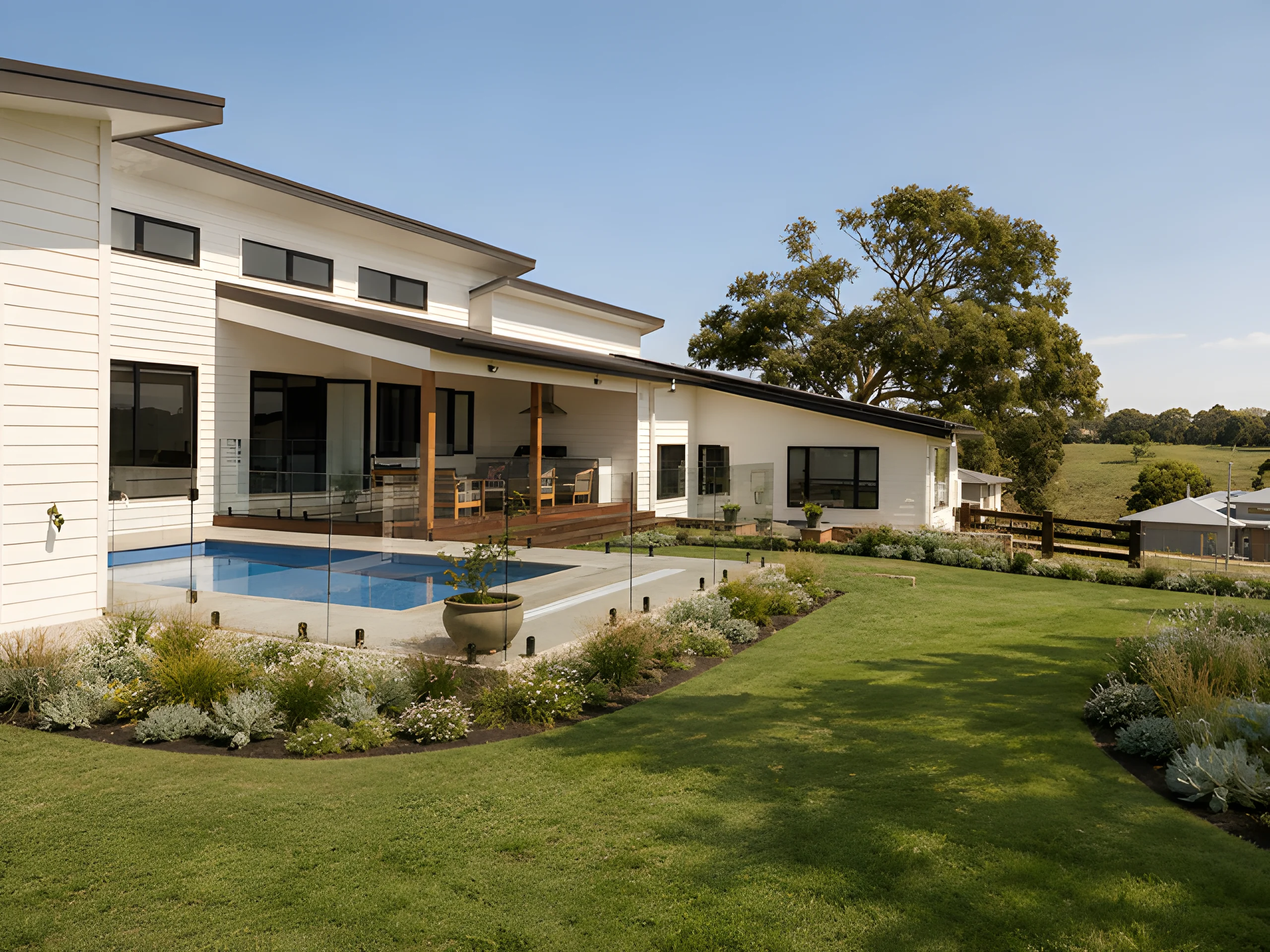 Conran Drive rear exterior with a swimming pool, garden and covered deck