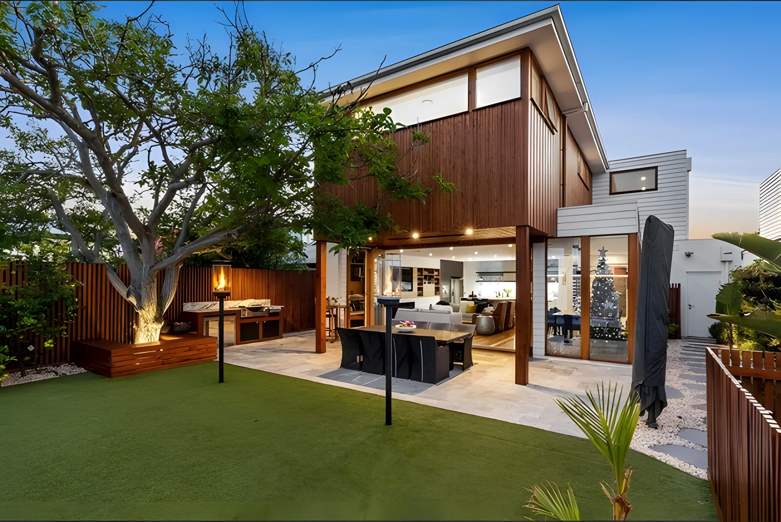 King Street rear exterior with timber cladding and a landscaped courtyard at dusk