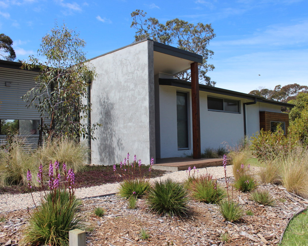 Contemporary Constructology home surrounded by native landscaping